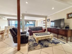 a living room with a couch and a table at BondMakers Hidden Gem in Hartbeespoort