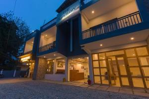 a large building with large windows at night at Sanctuary Boutique Hotel in Bhīm Tāl