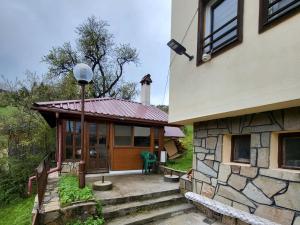 a house with a porch and a building at Вила Беевски in Gela