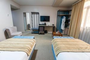 a hospital room with two beds and a desk at Onyx Hotel Bishkek in Bishkek +78 photos