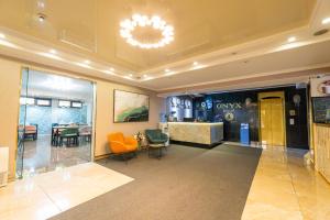 a lobby with chairs and a table in a building at Onyx Hotel Bishkek in Bishkek