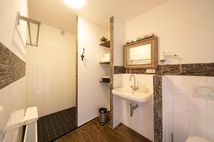 a bathroom with a sink and a mirror at Ferienhaus Lemmerheide in Rüthen +28 photos