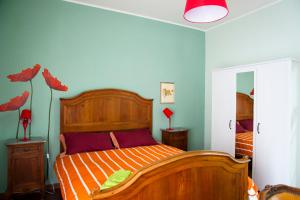 a bedroom with a large wooden bed in a room at Alma b&b in Crotone +22 photos