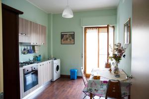 a kitchen with a table and a dining room at Alma b&b in Crotone