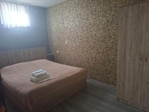 a bedroom with a bed with folded towels on it at Star Zvartnots Hotel in Pʼarakʼar