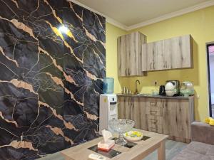 a kitchen with a black and brown marble wall at Star Zvartnots Hotel in Pʼarakʼar