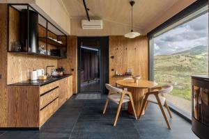 a kitchen and dining room with a table and chairs at Krasnyk Resort in Verkhovyna