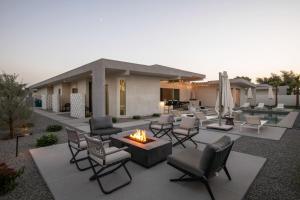 a patio with chairs and a fire pit at Mercury @ Elemento49 - Pool Spa - Sleeps 16 in Indio