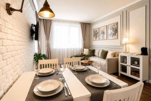 a dining room and living room with a table and chairs at Cozy & Elegant Stay in Veliko Tŭrnovo