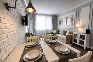 a dining room with a table and a living room at Cozy & Elegant Stay in Veliko Tŭrnovo +6 photos