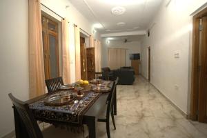 a dining room with a table and chairs with food on it at Jhumelo Homestay, Ukhimath in Ukhimath +20 photos
