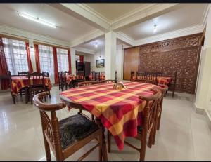 a dining room with a table and chairs in a room at Apsara Guest House, Peaceful Area in Central Shillong in Shillong