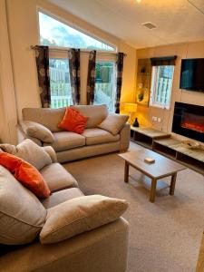 a living room with two couches and a tv at Southerness Holiday Home Cheri Sleeps 4 Mon-Fri Fri-Mon with Solway Holiday Homes in Mainsriddle