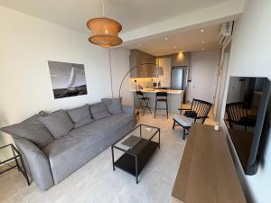 a living room with a gray couch and a table at Panoramic Sea View in Budva