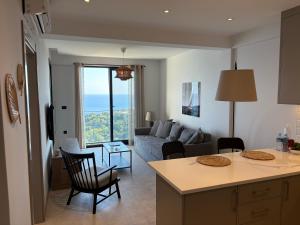 a kitchen and living room with a couch and a table at Panoramic Sea View in Budva