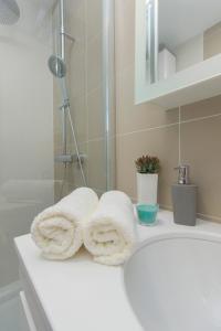 a bathroom with two towels on a sink at Apartments Zorka in Primošten
