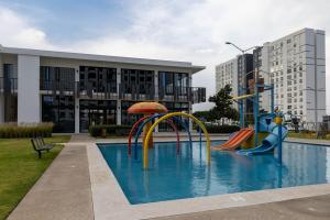 a swimming pool with a playground in front of a building at Sky Luxury Residence, 12th Floor, Panoramic in Guadalajara