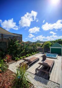 a patio with lounge chairs and a swimming pool at Villa Eugénie in Gustavia