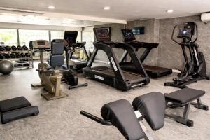 a gym with several treadmills and exercise bikes at The Savannah Hotel, Garki in Abuja