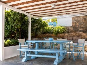a blue table and chairs on a patio at Cozy Summer House in Mikonos