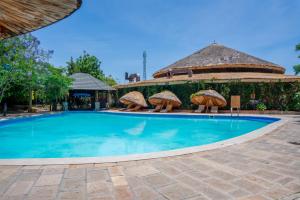 a large swimming pool with chairs and a building at Kuriftu Resort & Spa Bishoftu in Debre Zeyit