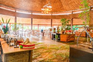 a restaurant with tables and chairs in a room at Kuriftu Resort & Spa Bishoftu in Debre Zeyit