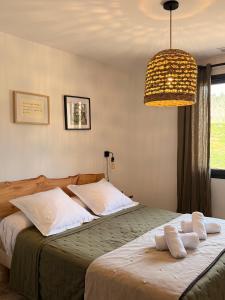 a bedroom with a bed with two towels on it at Mazet Brunelly in Paradou +31 photos