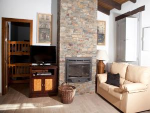a living room with a couch and a fireplace at Casa Rural Vega el Dorado in San Pablo