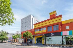 a colorful building on the side of a street at Sans Hotel International Surabaya in Gubeng