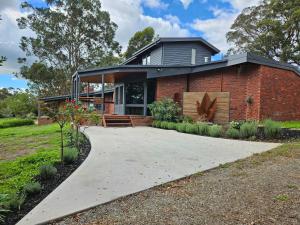 a brick house with a walkway in front of it at Hill Top Park - Apple Tree Studio in Kilmore