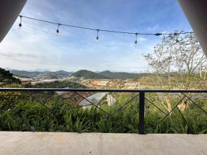 a view of the mountains from a balcony with lights at DaLart Glamping & Coffee in Ấp Ða Lôc