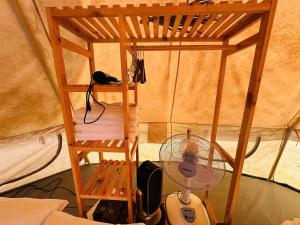 a small room with a fan and a desk at DaLart Glamping & Coffee in Ấp Ða Lôc