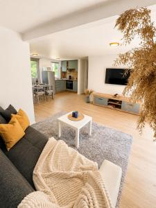 a living room with a couch and a table at Peaceful Garden Hideaway in Gárdony