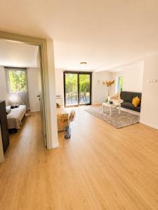 a living room with a couch and a table at Peaceful Garden Hideaway in Gárdony