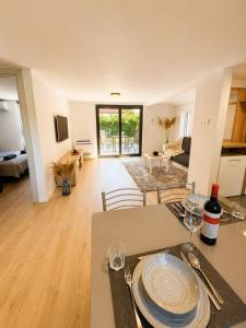 a kitchen and living room with a table and chairs at Peaceful Garden Hideaway in Gárdony