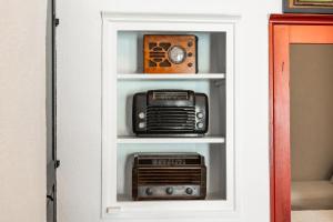 a cabinet with a radio and other items on it at Timedrops Santorini Villas-Private pool in Emporio