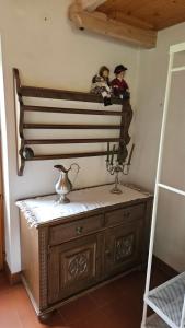 two dolls sitting on top of a dresser in a room at Gartenidylle Melk in Melk