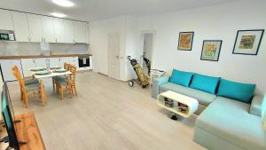 a living room with a blue couch and a table at Luxury Lighthouse Golf Apartment in Balchik