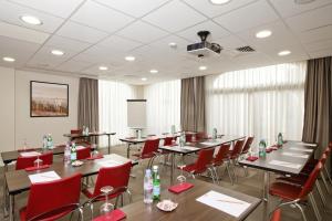 a conference room with tables and red chairs at Residhome Arcachon Plazza in Arcachon