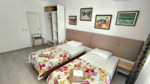 a hotel room with two beds and a chair at Luxury Lighthouse Golf Apartment in Balchik