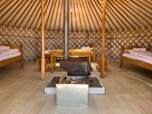 a yurt with two beds and a stove in it at Blue Pearl - Khovsgol Lake in Khyaktil