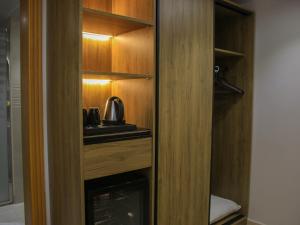 a wooden cupboard with a tea kettle in it at فندق برج جزيرة العرب in Medina