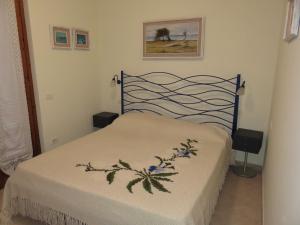 a bedroom with a bed with a black head board at Gli Oleandri in Capoliveri