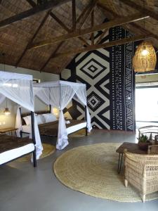 a room with two bunk beds and a rug at Honey Badger Lodge in Moshi