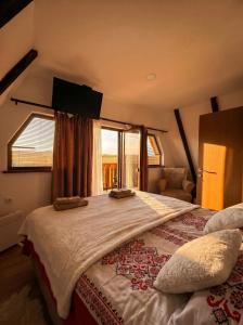 a large bed in a room with a window at Iskrin breg in Ribnica