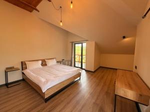 a large bedroom with a bed and a window at Mountain Symphony Cottage Dilijan in Dilijan +35 photos