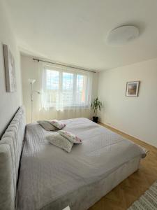a bedroom with a large bed with two pillows on it at Home place in Louny