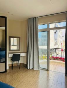 a room with a view of a balcony with a window at 7th Circle Suite in Umm Uthainah