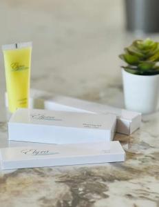 a glass of beer and two white boxes on a table at 7th Circle Suite in Umm Uthainah