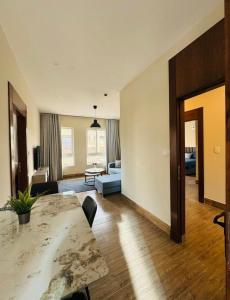 a living room with a table and a couch at 7th Circle Suite in Umm Uthainah